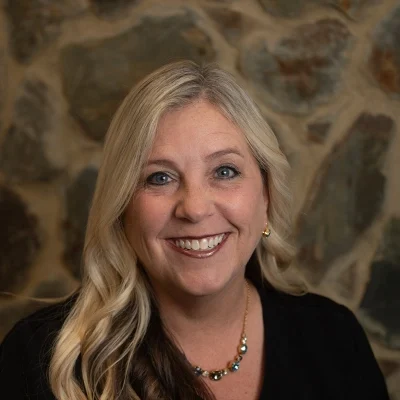 Angela Smiling In Front Of Cobble Wall