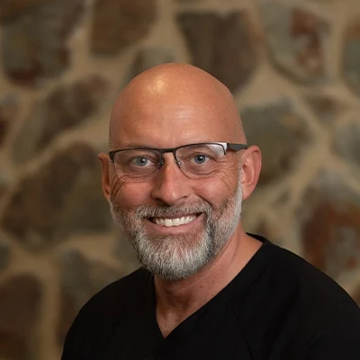 John Smiling In Front Of Cobble Wall