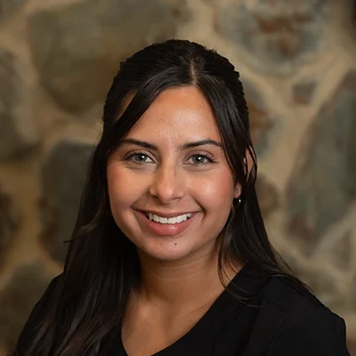 Kim Smiling In Front Of Cobble Wall