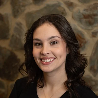 Lexi Smiling In Front Of Cobble Wall