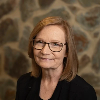 Lisa Smiling In Front Of Cobble Wall